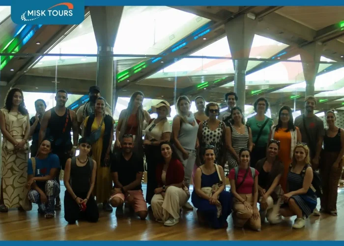 A-large-group-of-smiling-tourists-posing-together-inside-the-modern-Bibliotheca-Alexandrina.