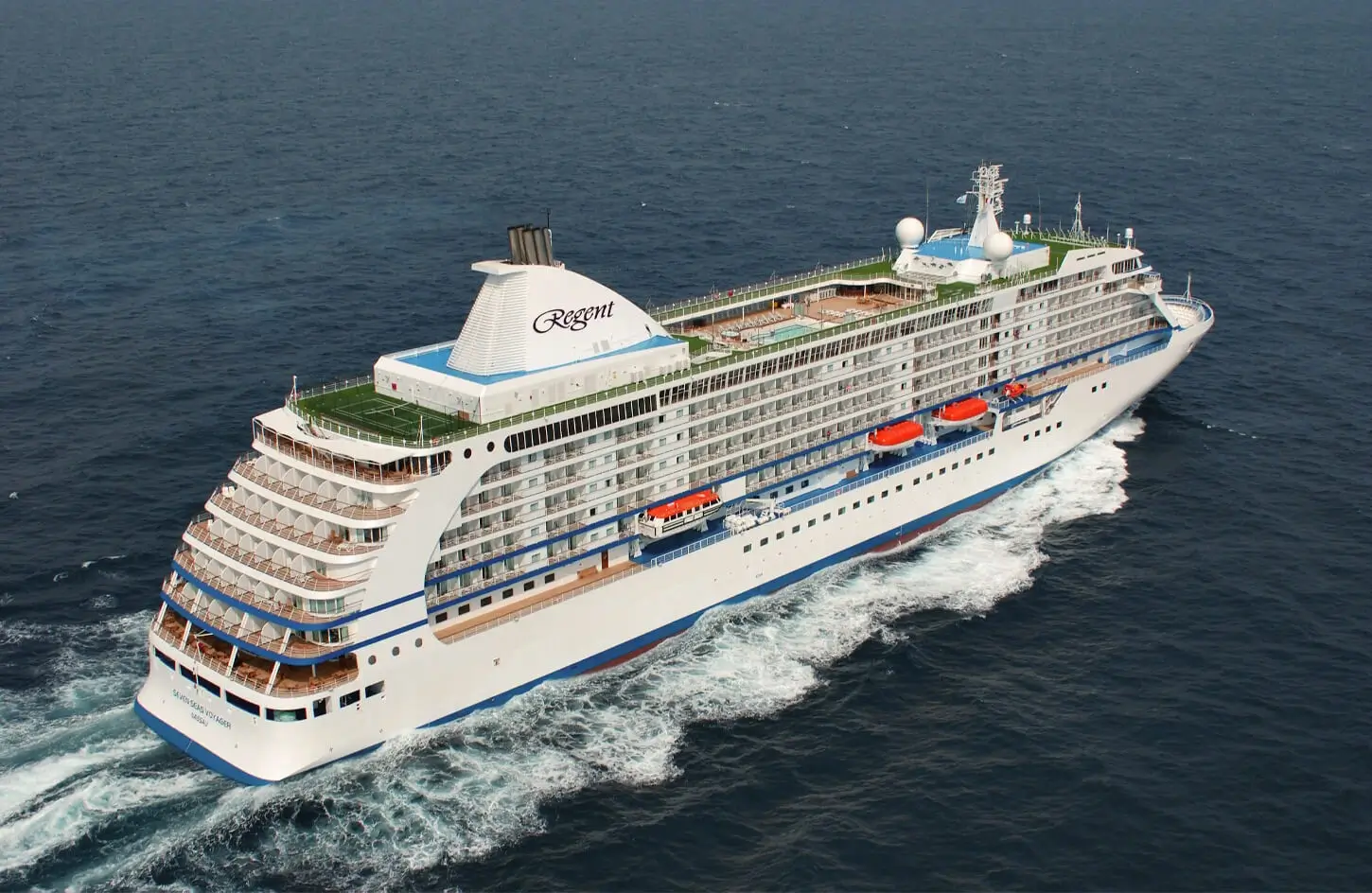 luxury-cruise-ship-egypt-red-sea-tours Aerial view of a luxury Regent ocean cruise liner sailing on deep blue water, perfect for a guide on luxury Red Sea and Egypt cruise vacations.