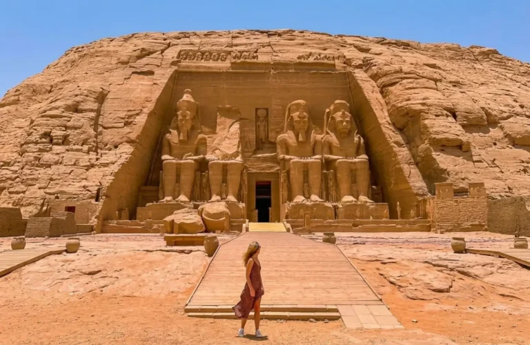 A female tourist walking toward the Great Temple of Ramesses II at Abu Simbel, demonstrating that it is safe to travel to Egypt.