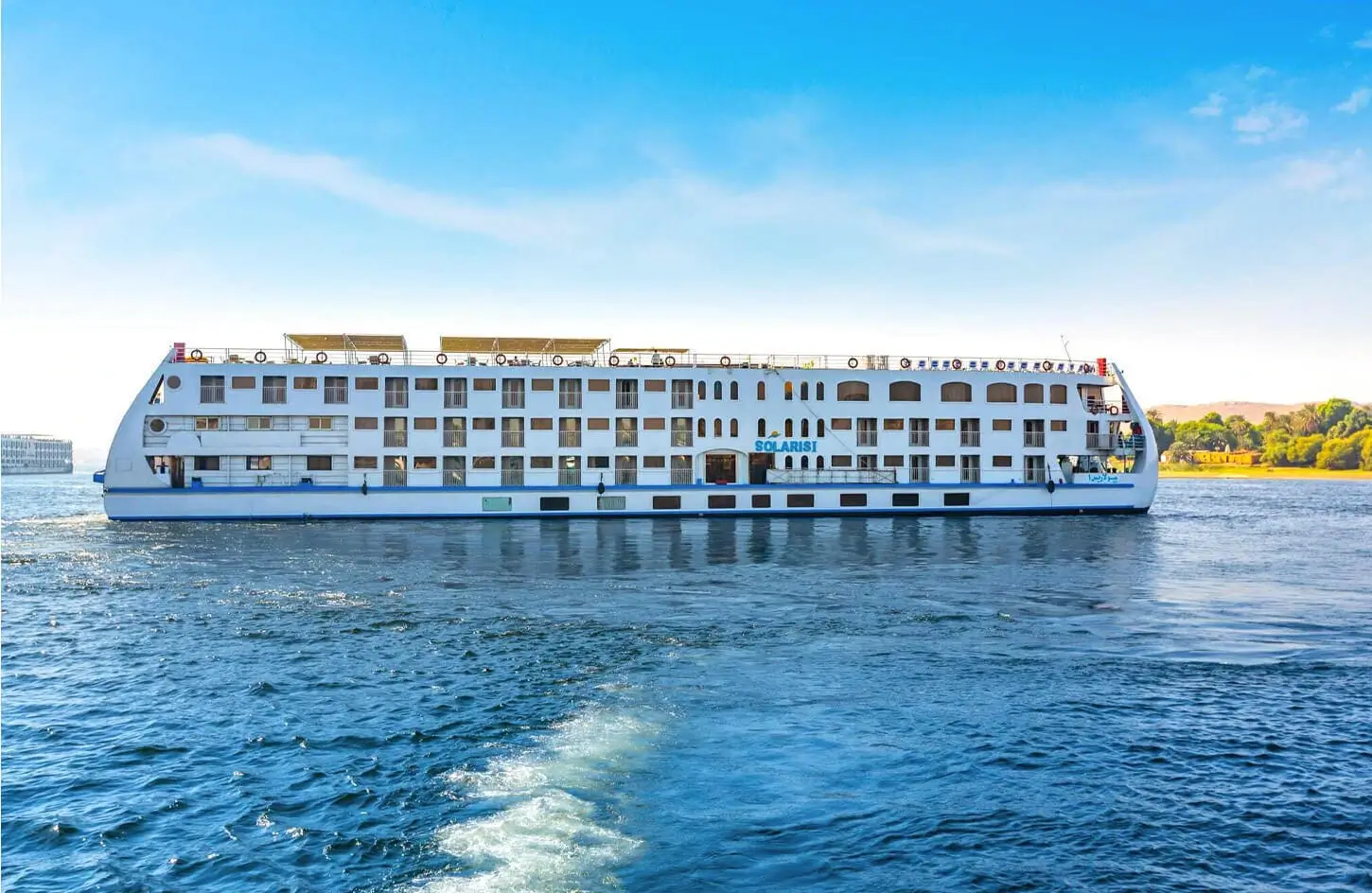 Solaris cruise ship sailing on the blue waters of the Nile River during a luxury 3 Nights Nile Cruise.