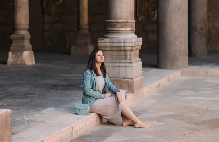 A stunning photo of a tourist sitting inside one of Cairo mosques