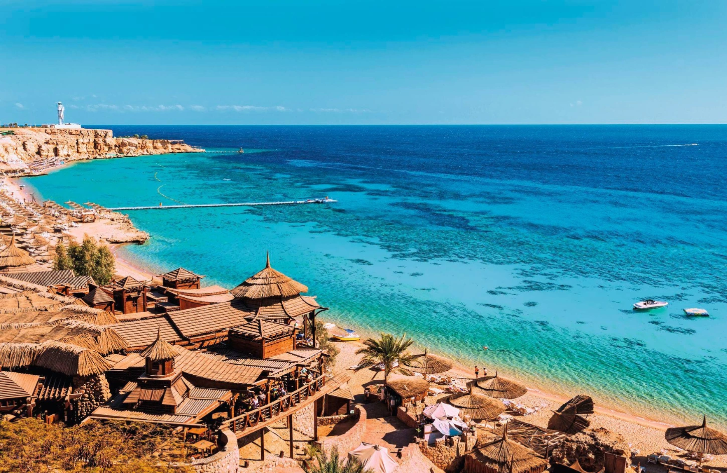 Panoramic view of a sun-soaked Red Sea beach resort with turquoise waters in Sharm El Sheikh when traveling to Egypt in April.